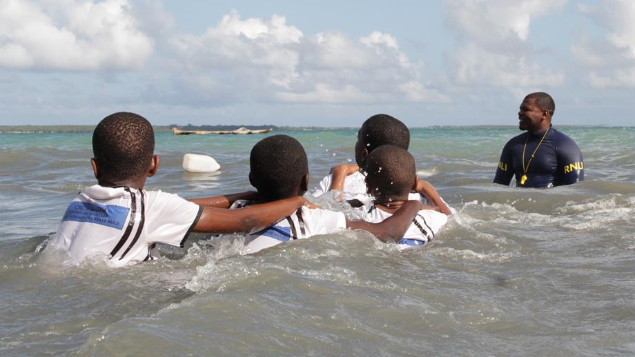 4 boys are on a swim safe session in the sea