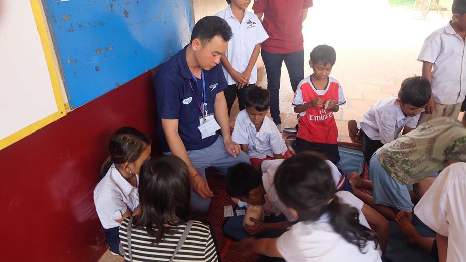 Children being taught CPR by a local trainer