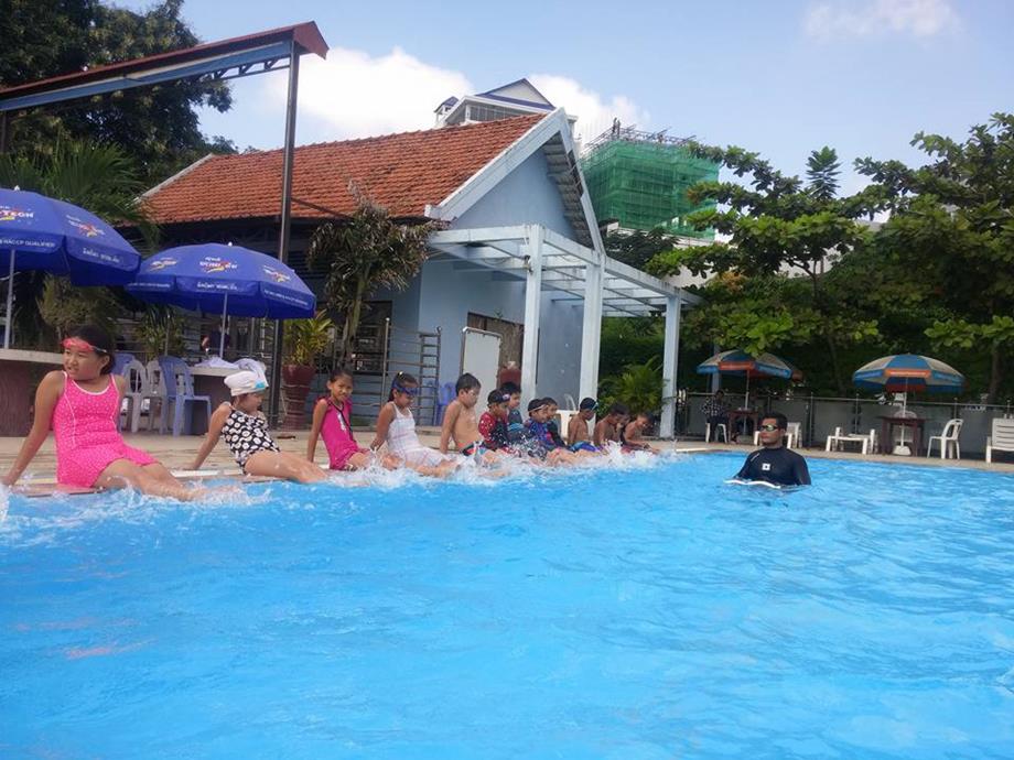 Children learning kick swimming skills 