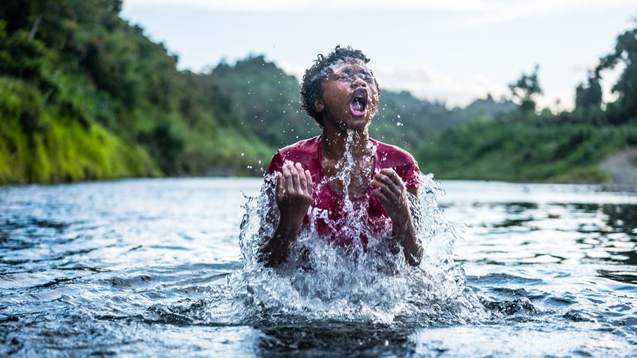 Ninia, 13, plays in the river near the Bucalevu village.