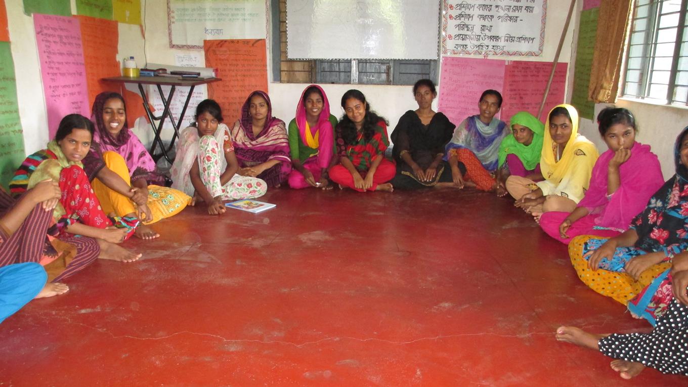 Women sat on the floor in a classroom